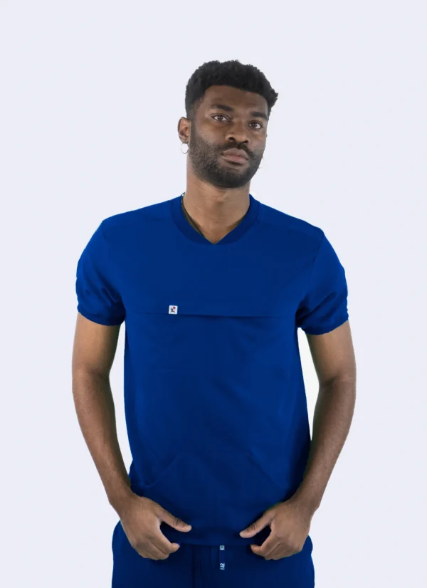 A man wearing a blue shirt with pockets.