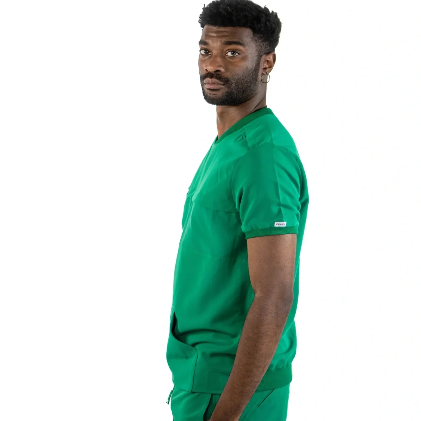 A man in green scrubs is standing up.